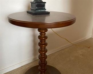 Two matching red chairs with table and lamp