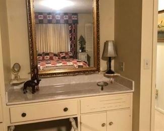 The built-in dressing table in the upstairs master bedroom with a bench and mirror that will be for sale.