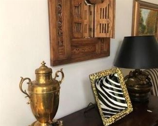 Accessories and wall decor above credenza in dining room.