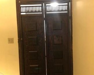 Set of carved Spanish style doors with carved panel above. Between entrance hall and kitchen.