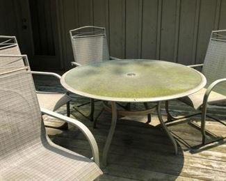 More moss covered lawn furniture needing power washed.