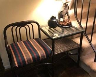 Rattan chair and attached table. Elephant lamp. In entrance hall.
