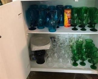 Sets of Blue, Clear and Green stemware.