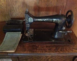 Antique New Willard Sewing Maching in a beautiful Tiger Oak Cabinet