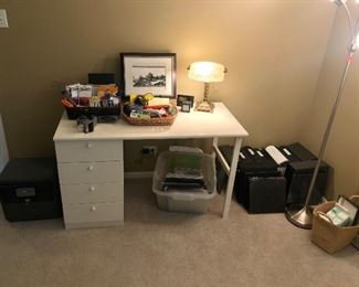 White desk and a variety of office supplies.