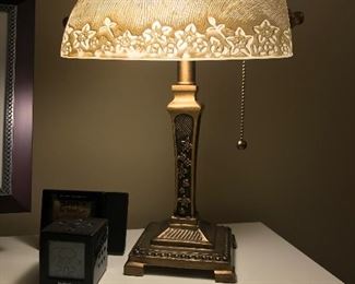 Small brass lamp with glass shade.