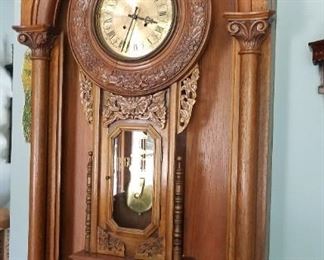 Antique clock in working order mounted on confessional door.