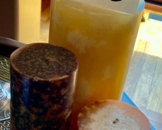 Lot 1510 $20.00. A Trio of Candles (Never Burned) In Yellow and Brown, Rust Tones. 8" T x 4.5" Diam., 6.5" T x 3" Diam., 4" T x 3.5" Diam.