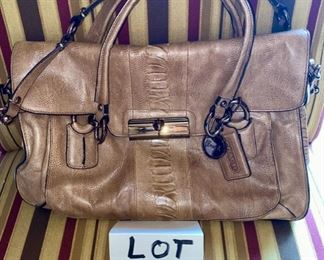 Lot 1521 $65.00. Authentic Coach Pebble Leather with Snake Skin treatment in the center of the bag. 2 Handles, plus removable shoulder strap. Excellent Condition, Official Coach Fob and Leather Tag. Front Flap with interesting metal closure, and handy Inside Zipper Compartments. Perfect for Fall!