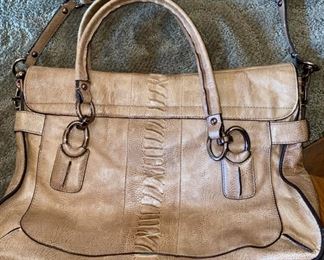 Lot 1521 $65.00. Opposite side Authentic Coach Pebble Leather with Snake Skin treatment in the center of the bag. 2 Handles, plus removable shoulder strap. Excellent Condition, Official Coach Fob and Leather Tag. Front Flap with interesting metal closure, and handy Inside Zipper Compartments. Perfect for Fall!