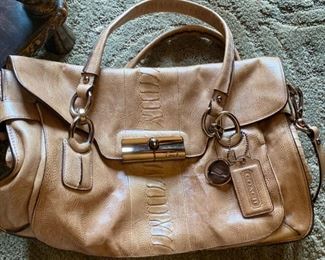 Lot 1521 $65.00. Authentic Coach Pebble Leather with Snake Skin treatment in the center of the bag. 2 Handles, plus removable shoulder strap. Excellent Condition, Official Coach Fob and Leather Tag. Front Flap with interesting metal closure, and handy Inside Zipper Compartments. Perfect for Fall!