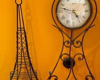 Lot 1526 $ 40.00 Metal Eiffel Tower Art and Clock with Pendulum and White Face. Battery Operated. Tower: 26.5" T x 12" W Clock: 28.5" T x 11" W
