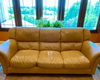 Lot 1534. $450 Tan Leather 3-Cushion Sofa with Rolled Arms and Attached Comfy Cushions in Great Shape and Color. Sofa 92" L x 40" H Back x 38" D Cushion 24" D x 17" H to Seat Cushion.