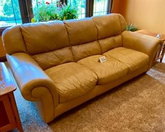 Lot 1534. $450 Tan Leather 3-Cushion Sofa with Rolled Arms and Attached Comfy Cushions in Great Shape and Color. Sofa 92" L x 40" H Back x 38" D Cushion 24" D x 17" H to Seat Cushion.