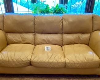 Lot 1534. $450 Tan Leather 3-Cushion Sofa with Rolled Arms and Attached Comfy Cushions in Great Shape and Color. Sofa 92" L x 40" H Back x 38" D Cushion 24" D x 17" H to Seat Cushion.