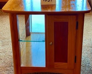 Lot 1537 $75.00 Maple Side Table w/ 1 Door in Front and Back, Glass Shelf, Maple and Cherry Veneers, The Top Surface shows wear and rough spots. Made by Riverside Furniture 26" D x 22" W x 24" H