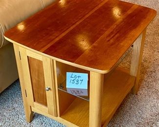 Lot 1537 $75.00 Maple Side Table w/ 1 Door in Front and Back, Glass Shelf, Maple and Cherry Veneers, The Top Surface shows wear and rough spots. Made by Riverside Furniture 26" D x 22" W x 24" H