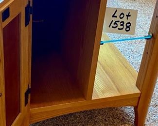 Lot 1538 $75.00 Maple Side Table w/ 1 Door in Front and Back, Glass Shelf, Maple and Cherry Veneers, The Top Surface shows wear and rough spots. Made by Riverside Furniture 26" D x 22" W x 24" H
