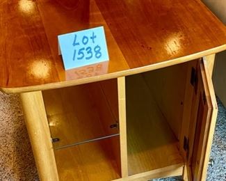 Lot 1538 $75.00 Maple Side Table w/ 1 Door in Front and Back, Glass Shelf, Maple and Cherry Veneers, The Top Surface shows wear and rough spots. Made by Riverside Furniture 26" D x 22" W x 24" H