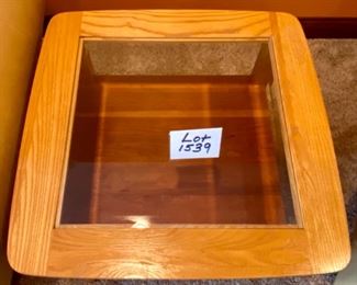 Lot 1539 $105.00 Matching Side Table with 18" Square Beveled Glass Top and Middle Shelf, Finished in Maple and Cherry Veneers, The Top Surface shows wear and rough spots by Riverside Furniture 26" Square x 24" H