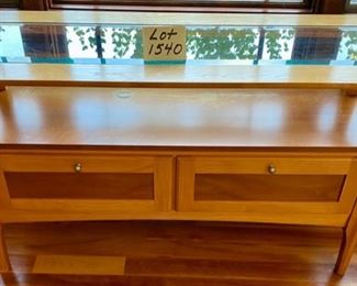 Lot 1540 $120.00 Matching Sofa Table with Beveled Glass Top and Middle Shelf, Finished in Maple and Cherry Veneers, The Top Surface shows wear and rough spots by Riverside Furniture 48" L x 16" D x 28" H