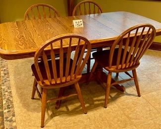 Lot 1564 $275.00 Solid Oak Kitchen Table w/ Under Table Leaf Storage and 4 Oak Spindle Back Chairs. Great for a Growing Family. Includes 1 Leaf. 49.5" L w/o Leaf x 34" W, Leaf is 17.75" W. Shown with Leaf