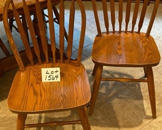 Lot 1564 $275.00 Solid Oak Kitchen Table w/ Under Table Leaf Storage and 4 Oak Spindle Back Chairs. Great for a Growing Family. Includes 1 Leaf. 49.5" L w/o Leaf x 34" W, Leaf is 17.75" W. Shown with Leaf