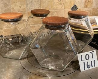 Lot 1611. $32.00. Lot of 4 Glass Candy Jars, or perhaps Canisters, 8.25" tall, with wooden lids. Great storage and Great Condition.