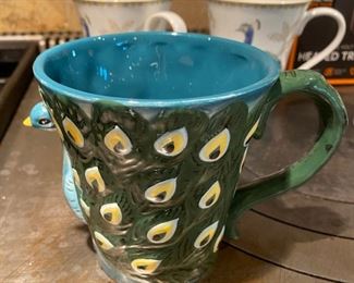Lot 1603. Asking $28 for all. Smart Gear Heated Travel Mug, New in Box, 2 Mugs Alumni from Truman State University, 1 Cool Peacock Shaped mug in relief, and 2 Peacock decorated mugs