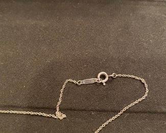 Lot 1607-A. Asking $150. Tiffany & Company necklace; 16" and Sterling Silver pendant has company name engraved in script