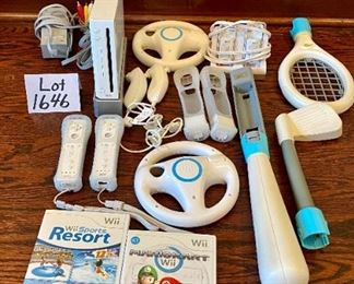 Lot 1646. $100.00 "The Wii Bundle": Wii Game Console, 2 Remote Controller, 2 Nunchucks, Mario Kart with 2 Wheels and Game, Wii Sports, Resort Sports Games and 2 Extra Battery Packs plus Nyko Battery Charger. $100.00"