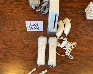 Lot 1646. $100.00 "The Wii Bundle": Wii Game Console, 2 Remote Controller, 2 Nunchucks, Mario Kart with 2 Wheels and Game, Wii Sports, Resort Sports Games and 2 Extra Battery Packs plus Nyko Battery Charger. $100.00"