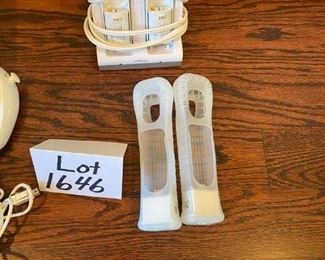 Lot 1646. $100.00 "The Wii Bundle": Wii Game Console, 2 Remote Controller, 2 Nunchucks, Mario Kart with 2 Wheels and Game, Wii Sports, Resort Sports Games and 2 Extra Battery Packs plus Nyko Battery Charger. $100.00"