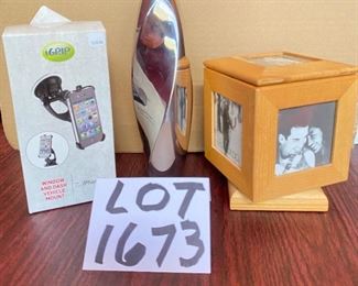 Lot 1673. $22 8" Nambe Twisted Bud Vase, Spinning photo cube, and window and dashboard iphone mount for an iphone 4