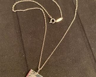 Lot 1607-A. Asking $150. Tiffany & Company necklace; 16" and Sterling Silver pendant has company name engraved in script