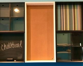 Lot 1716 Asking $ 200.00 Pottery Barn Teen MiYO Wall Unit at this home in one of their Children's Bedroom. This unit hangs on the wall and has several cubbies, Chalkboard as well as a large Bulletin board. Orig Pd. $414.91