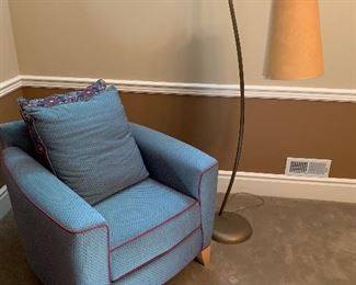 Contemporary style arm chair and curved floor lamp 