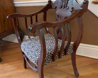 Antique wooden arm chair with carved details 