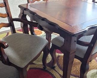 kitchen table with 4 chairs, rug  Note:  chairs are on rollers