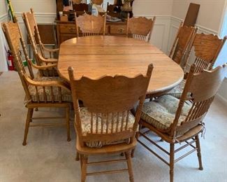#24	Austin oak dining table pedistal claw foot base with 8 chairs, (2 captains chairs)   65-76x48x29	 $375.00 
