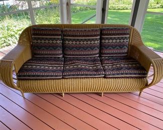 Incredible 1920’s/1930’s wicker sofa with custom cushions.  85” Wide
