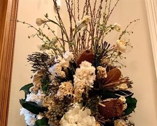 Close up of floral arrangement in black and gold urn