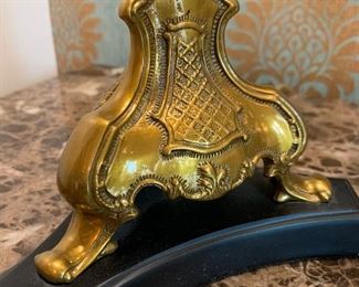 Close up of brass base on candlestick lamps with silk shade.
