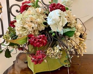 $100 - Beautiful floral arrangement in green planter. The container measures 9” x 7” and the planter with floral arrangement measures a total of 19” tall.