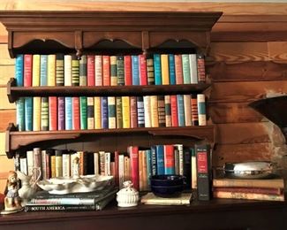 Bookshelf full of vintage books, figurines, silverplate, more