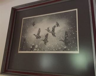 Framed and matted print of ducks in flight.