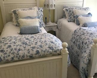 Twin beds , complete with bedding