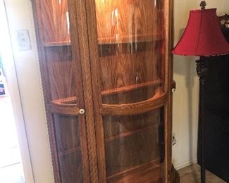 several beautiful solid wood lighted curio cabinets- this one is downstairs- and has curved glass -