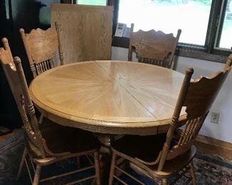 Pictured Round  Oak Table and Four Chairs With  Leaf, two additional chairs available