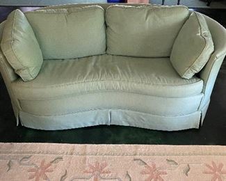 Light green lien loveseat with curved front